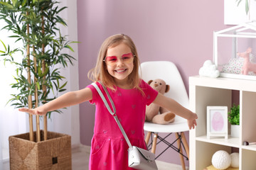 Portrait of stylish little girl at home