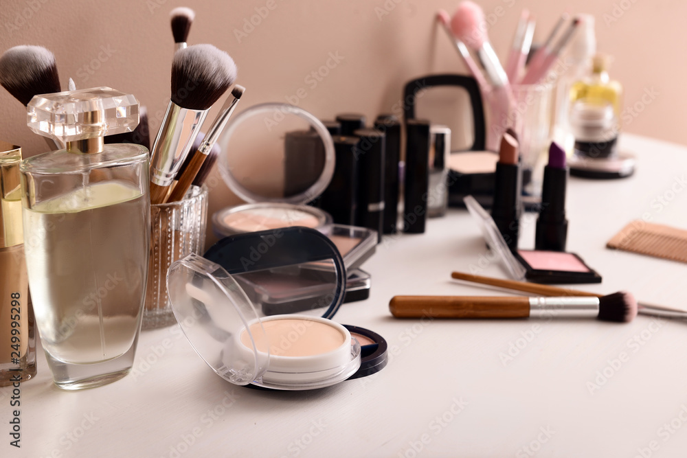 Professional makeup cosmetics with brushes on dressing table