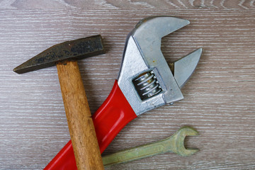  Swedish adjustable wrench and rusty metal hammer