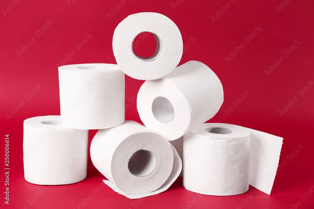 Rolls of toilet paper on color background