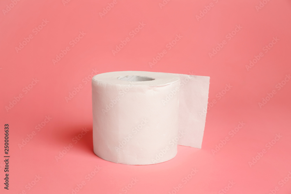 Roll of toilet paper on color background