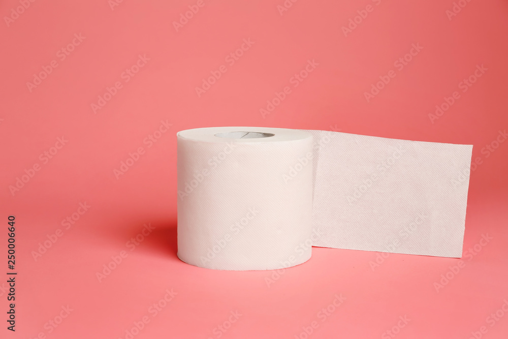 Roll of toilet paper on color background