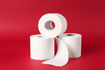 Rolls of toilet paper on color background