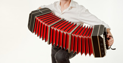 GOMEL, BELARUS - FEBRUARY 14, 2019: a bandoneon musical instrument in the hands of a musician.