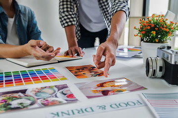 Wall Mural - Asian advertising designer creative start-up team discussing ideas in office.