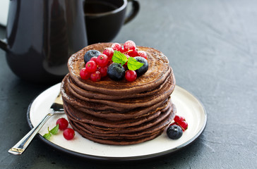 Wall Mural - Chocolate pancakes with berries.