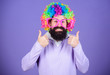 © be free - Party fun. Enjoy being crazy. Feel free to express yourself. Having fun. Holiday fun and carnival concept. Man bearded wear colorful wig and funny glasses on violet background. Clown and circus