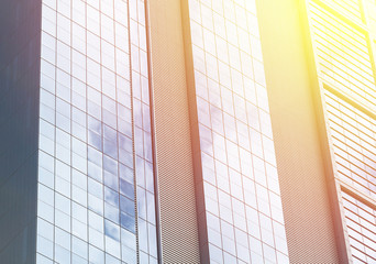 Building facade with modern window design for steel glass office tower.  Copy space and fade.