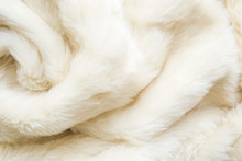 Light, White, Furry Blanket With Wavy Folds As Background. Top View. Closeup.