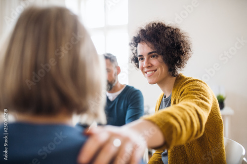 Cuadros en Lienzo Men and women sitting in a circle during group therapy, supporting each other