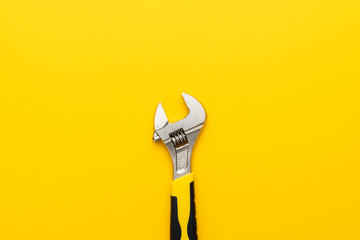 Wall Mural - adjustable wrench with yellow handle on the yellow background