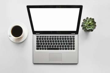 Wall Mural - Open laptop, coffee, plant on office table. Top view with space for text on screen.