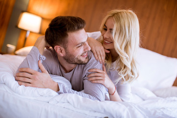 Romantic couple in love lying in bed together