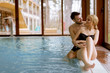 © BGStock72 - Loving couple relaxing in the spa by swimming pool