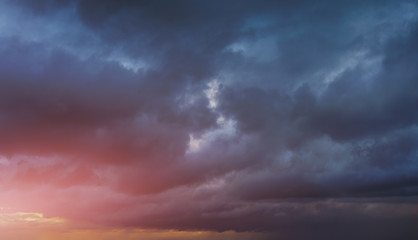 Wall Mural - background of cloudy dark sky at sunset