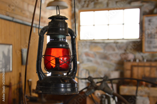 Black Oil Lamp With Red Glass In Old Barn Workshop Buy This