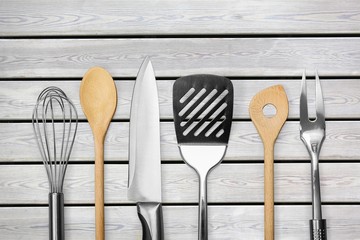 Wall Mural - Kitchen metal and wooden utensil on  background