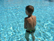 © Dawid G - European boy prepares to swim in swimming pool. Healthy boy stands in swimming pool , European young kid training with swim goggles