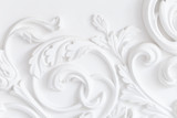 Fototapeta  - Beautiful ornate white decorative plaster moldings in studio