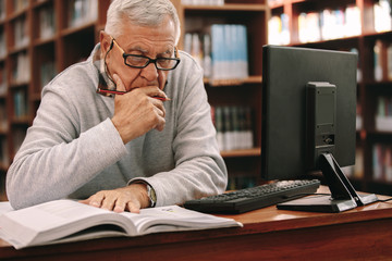 Wall Mural - Senior man studying in classroom