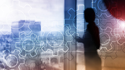 Wall Mural - double exposure gears mechanism on blurred background. business and industrial process automation co
