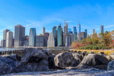 Fototapeta Miasta - Landscape photo of Manhattan skyline with rocks in the foreground.