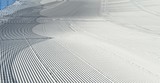 Fototapeta Miasto - Trace of snow groomer on snow. Snow velvet. Ski and snowboard track. Prepared snow track. Cortina D'Ampezzo, Italy