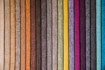 Wall Mural - Colorful and bright fabric samples of furniture and clothing upholstery. Close-up of a palette of textile abstract stripes of different colors