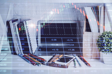 Double exposure of stock market chart and office desktop on background. financial strategy concept.