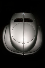 Wall Mural - Rear view of fancy elegant retro car on dark background