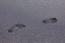 Footprints on black sand