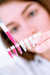 Poster - Young woman fill PCR microtubes with dispenser