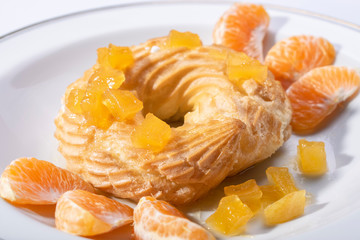 cake and tangerine on a plate