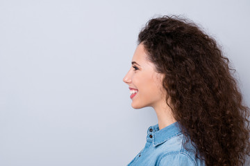 Close-up profile side view portrait of her she nice-looking cute lovely well-groomed charming attractive cheerful wavy-haired girl copy space isolated over gray pastel background