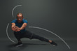 © Friends Stock - Always in a great shape. Sportsman is stretching standing over dark background. Graphic drawing.