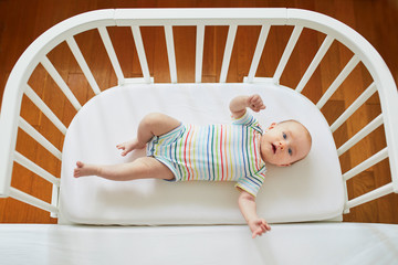 Wall Mural - Baby girl in co-sleeper crib