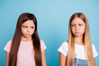 © deagreez - Close-up portrait of two people nice cute lovely attractive charming sad mad offended disappointed gloomy straight-haired pre-teen girls isolated over blue pastel background