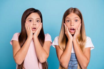 Poster - Close-up portrait of two people nice cute attractive charming scared frightened funny straight-haired pre-teen girls touching cheeks scary news isolated over blue pastel background