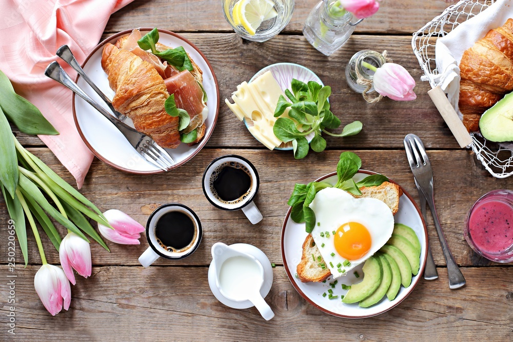 Breakfast food table. Festive brunch set, meal variety with fried egg ...