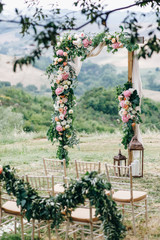 Wall Mural - Italian wedding decoration. Green eucalyptus, oranges and pink flowers decorate wedding altar