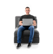 © Pixel-Shot - Young man with laptop sitting in armchair against white background