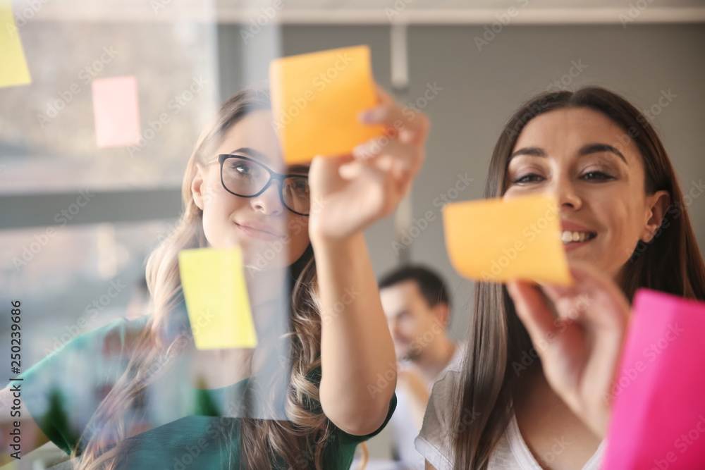 View at business team during meeting in office through transparent board