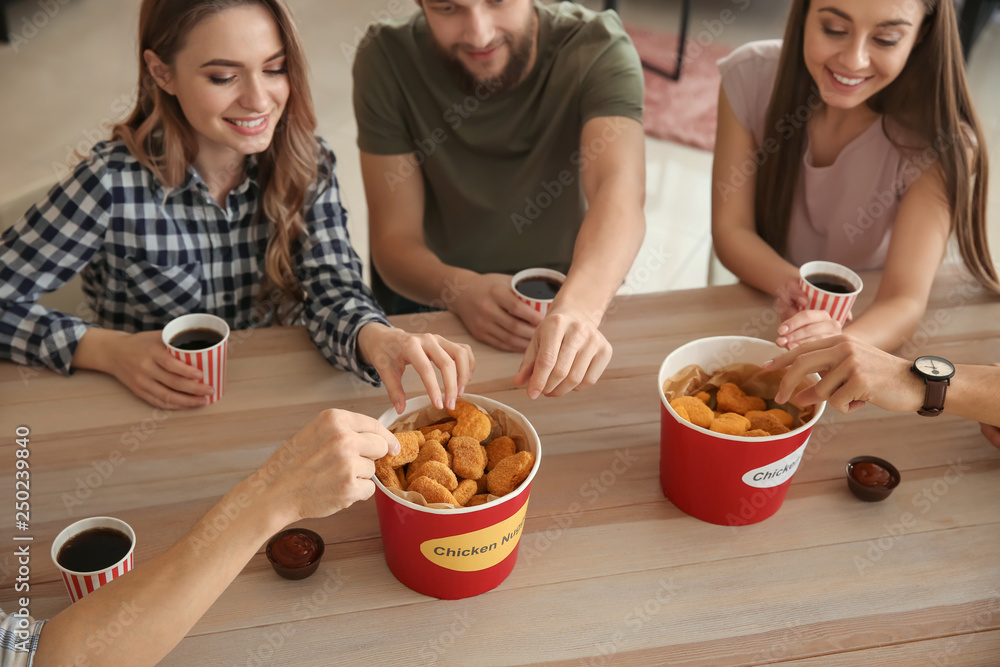 Group of friends eating nuggets at home