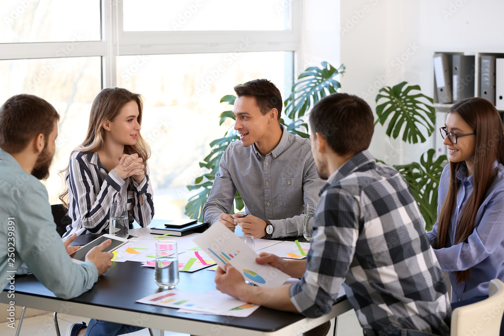 Group of people discussing business plan in office