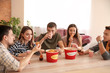 © Pixel-Shot - Group of friends eating nuggets at home