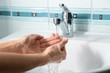 © Pixel-Shot - Woman washing hands in sink