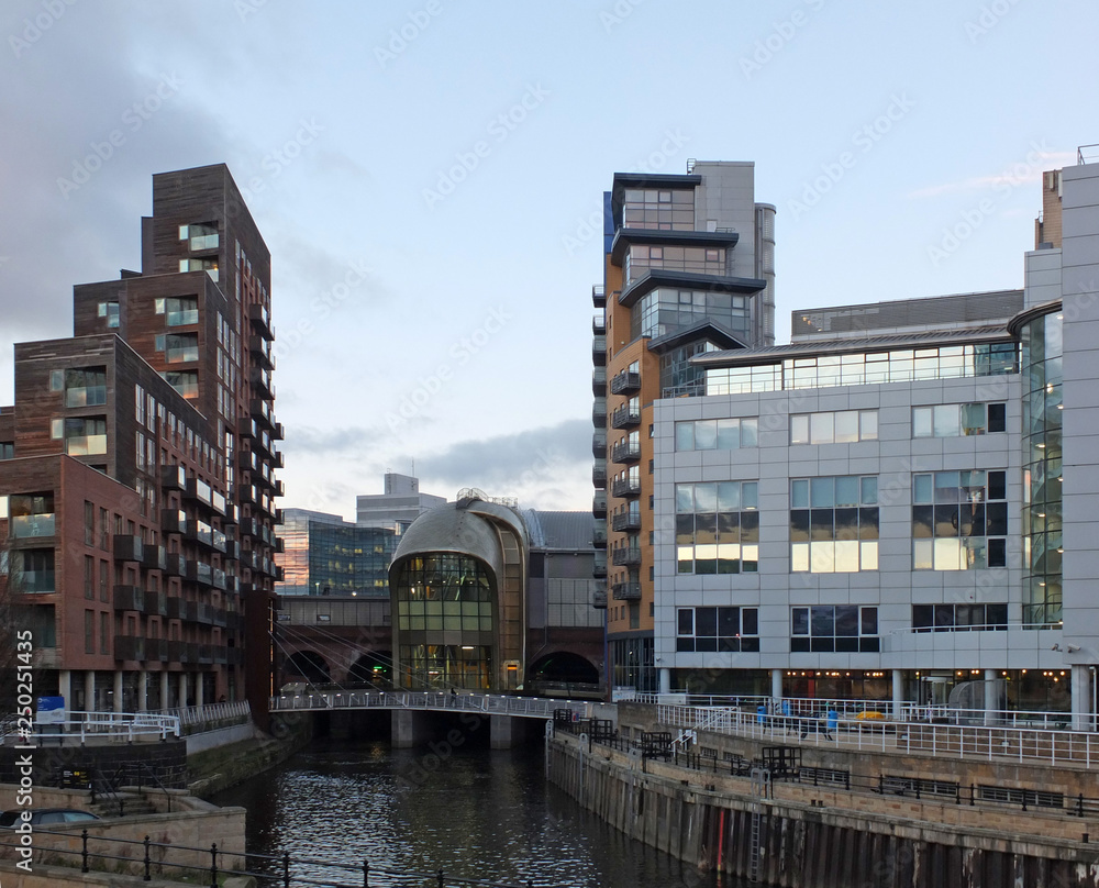 cityscape view of leeds with the river aire entering the dark arches ...