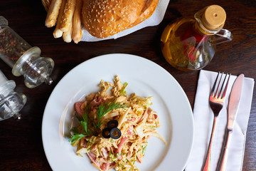  different dishes on a wooden table, cutlery, napkins, bread, seasonings, salt. The overall concept of the lunch menu