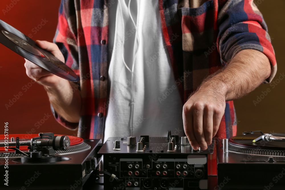 Male DJ playing music in club