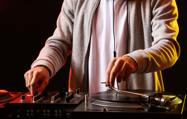 Male DJ playing music in club